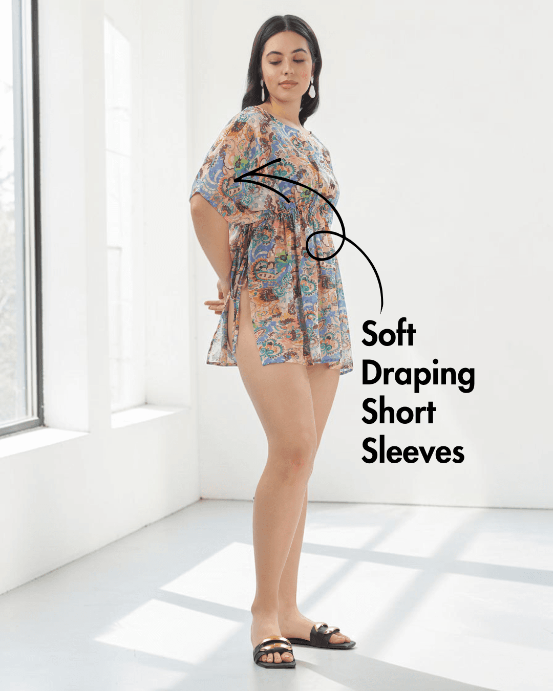 Model in colorful kaftan with soft draping short sleeves and wide boat neckline