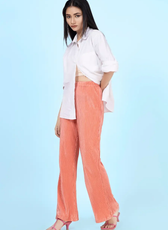 Model wearing high-waisted flared pants from the 'Brook' sewing pattern. Stylish wide-leg silhouette with an elastic waistband for comfort and elegance.