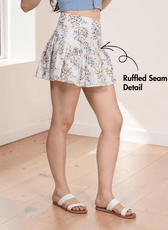 Side view of floral mini skirt with ruffled seam detail and fitted waist