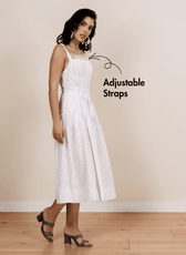 Model wearing white sundress with square neckline, adjustable straps, and side pockets, showcasing the Fiona sewing pattern