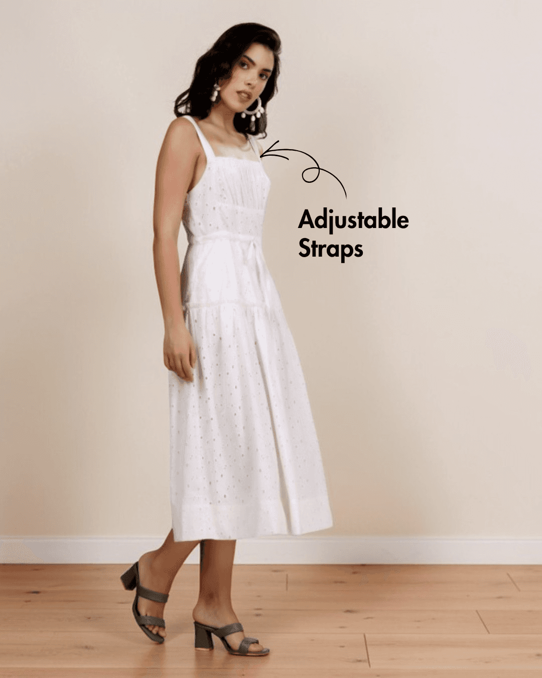 Model wearing white sundress with square neckline, adjustable straps, and side pockets, showcasing the Fiona sewing pattern