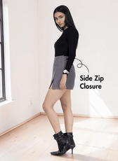 Model wearing gray skort with back pockets and side zipper detail