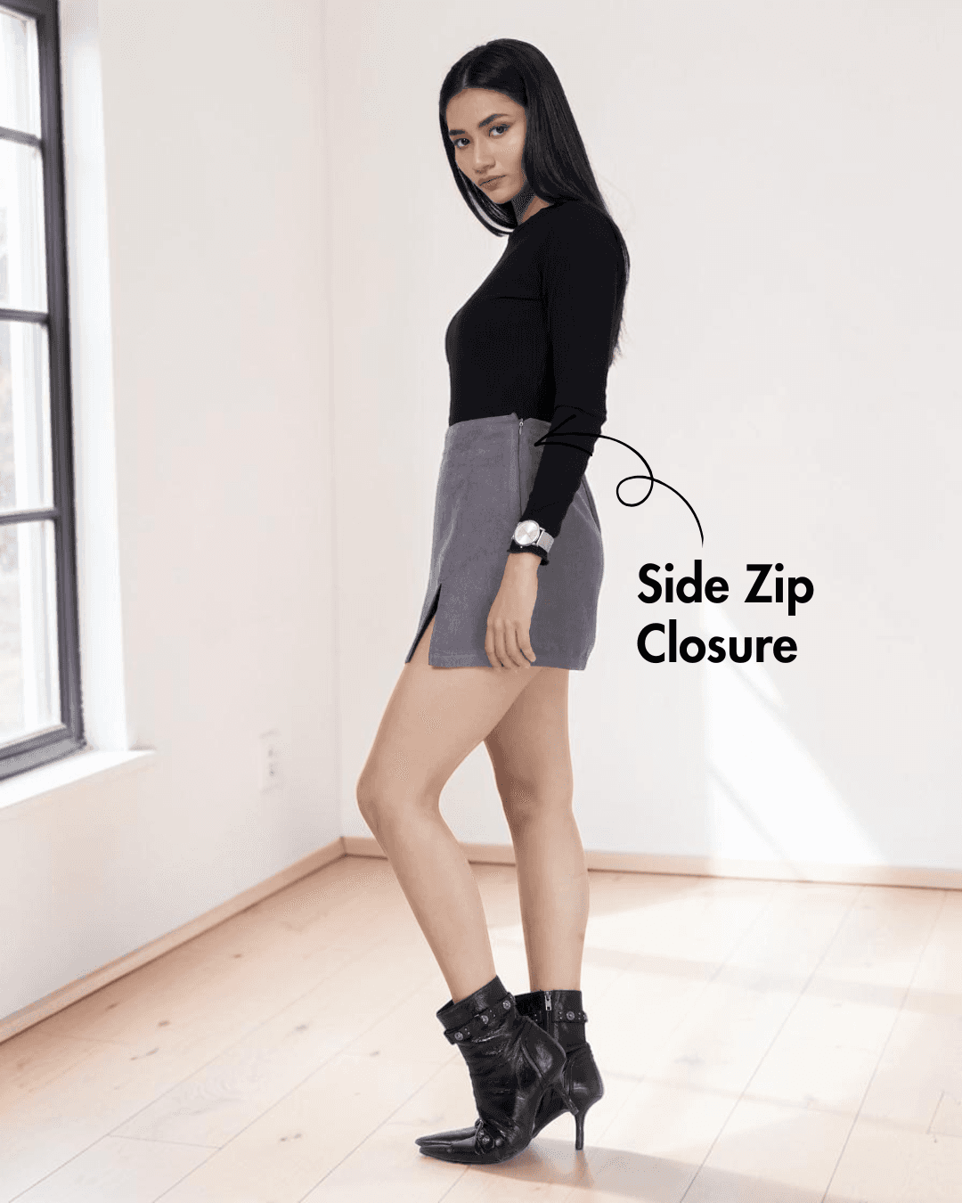 Model wearing gray skort with back pockets and side zipper detail