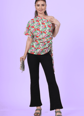 Front view of a model wearing the one shoulder kimono top paired with black trousers