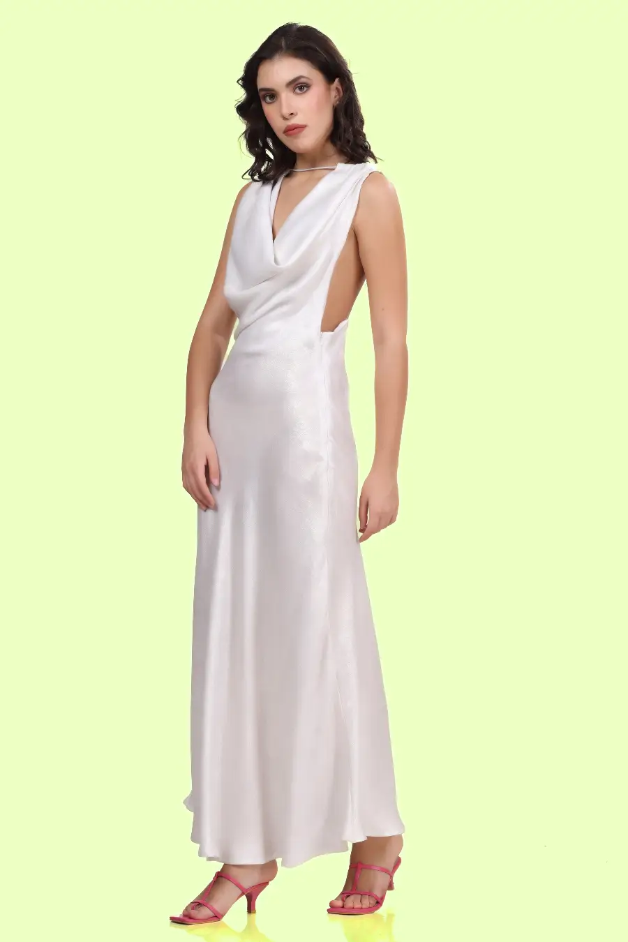 Side angle shot of a model wearing backless cowl neck gown