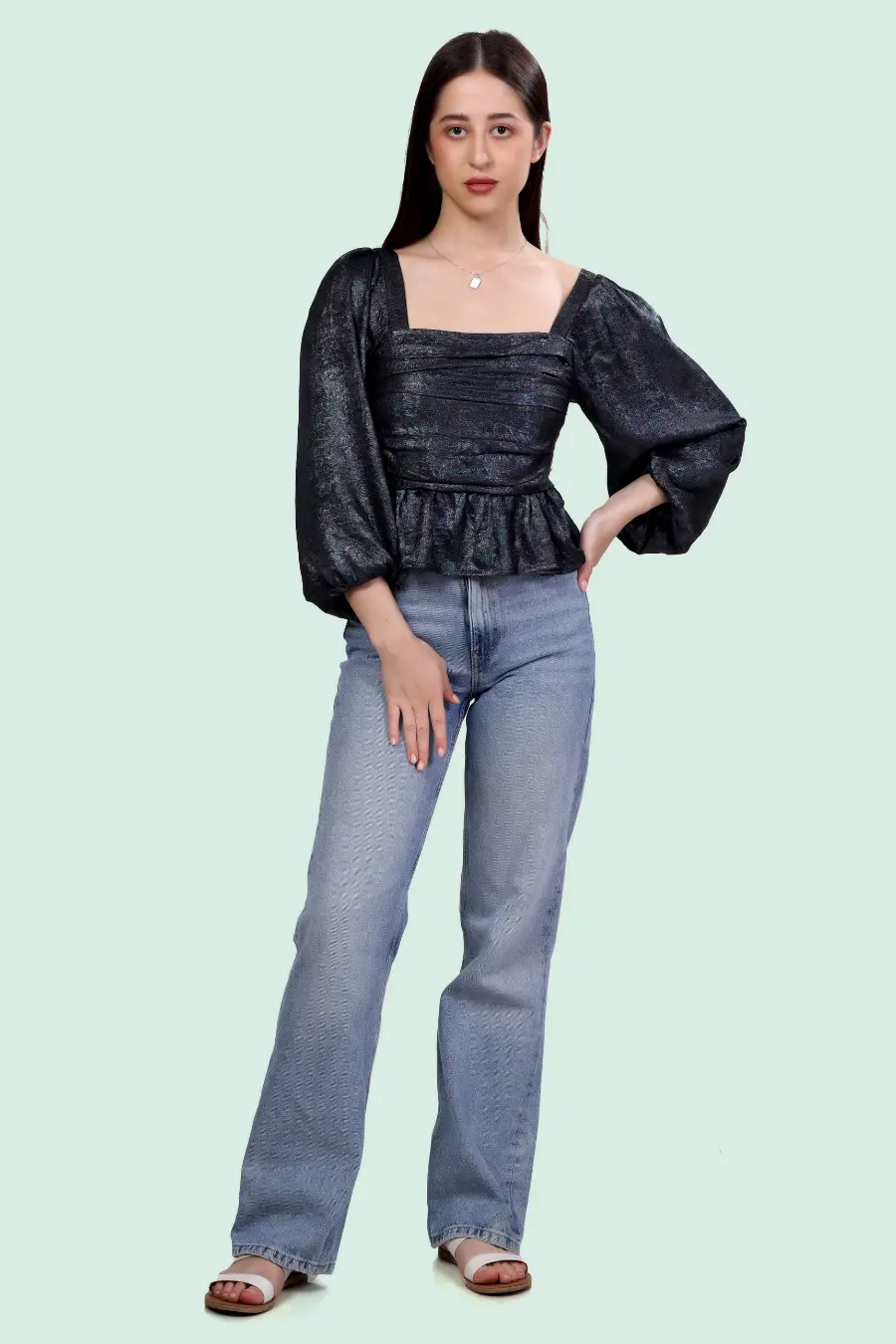 Full front view of Reese Peplum Top Sewing Pattern in black, styled with jeans to showcase puff sleeves and peplum hemline.