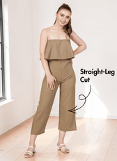 Model wearing beige strapless jumpsuit sewing pattern with overlay and straight-leg design, front view