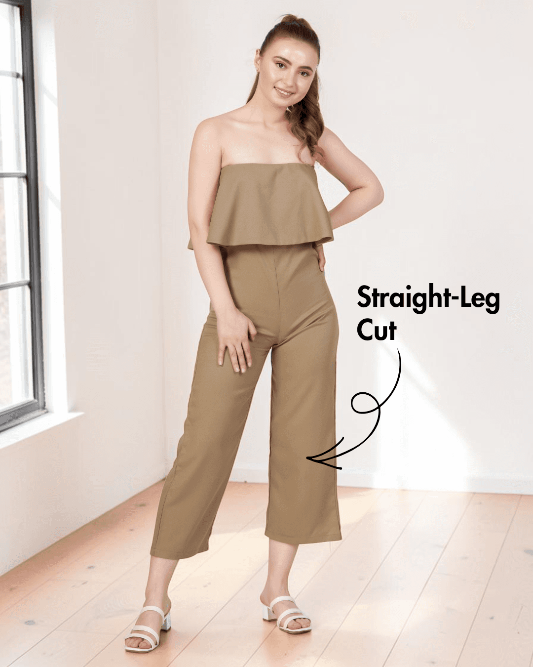 Model wearing beige strapless jumpsuit sewing pattern with overlay and straight-leg design, front view