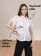 Front view of white eyelet short sleeve women's sewing pattern top with structured collar