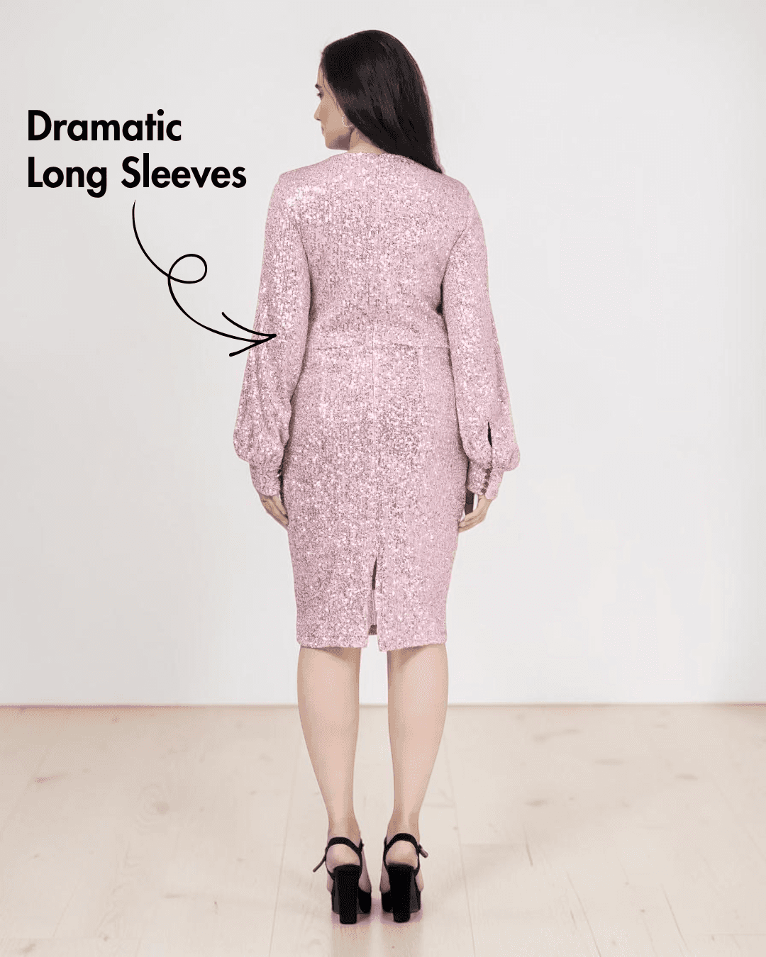 Back view of woman in pink sequin dress with dramatic long sleeves and slit