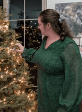 Side view of woman in green dress with long sleeves and floral pattern, showcasing celestia sheath dress sewing pattern