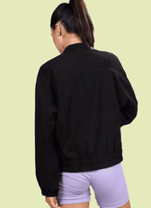 Back view of the Naomi windbreaker, featuring an elasticated hem and a relaxed fit. Ideal for layering and everyday wear.