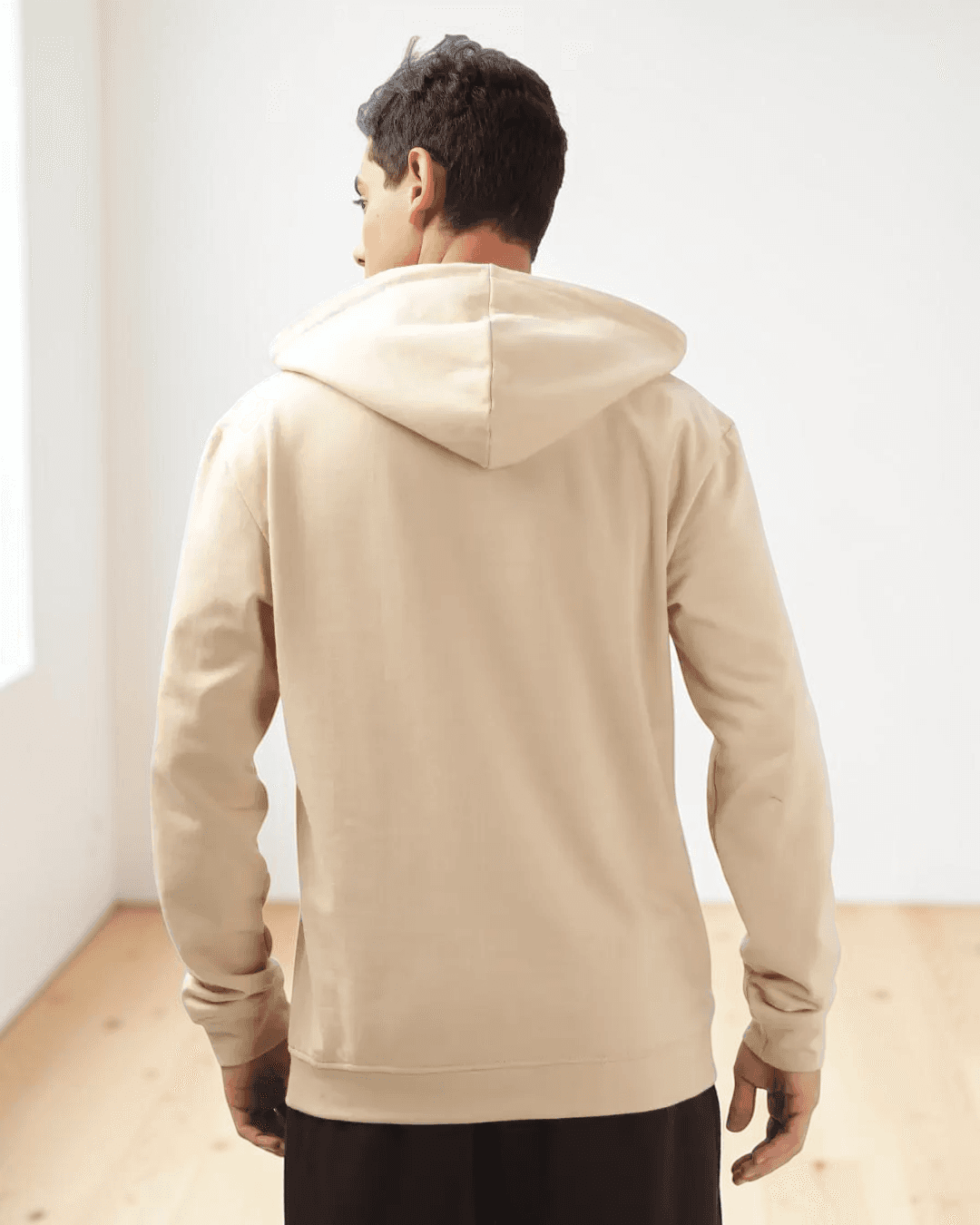 Back view of beige hoodie sewing pattern with adjustable drawstring hood