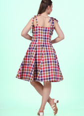 Back view of a Model wearing a sleeveless midi dress with adjustable tie-shoulder straps and a square neckline sewed with Winslet's patterns