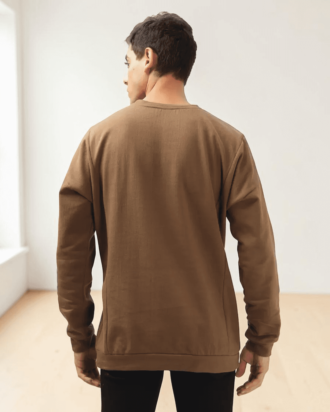 Back view of men's brown sweatshirt sewing pattern with classic long sleeves and panel details