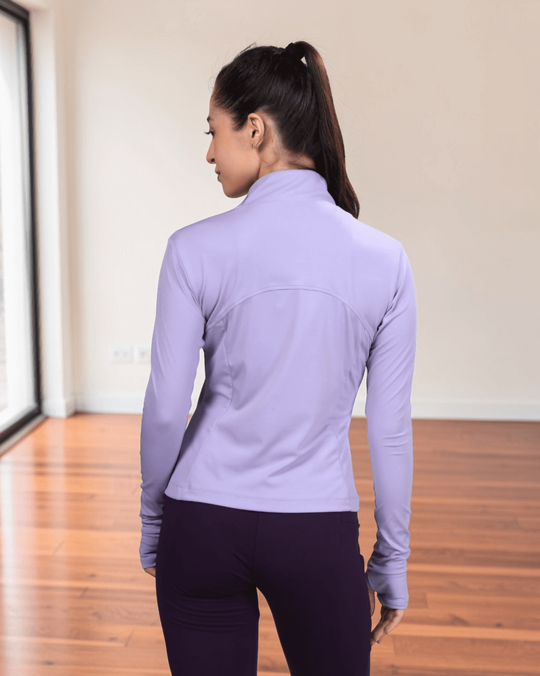 Women wearing lavender sports jacket with high collar and full zip
