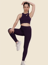 Model demonstrating flexibility in Layla running leggings. High-waisted, snug fit with side pockets, designed for active and casual wear.