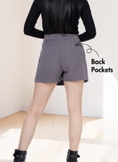 Gray mini skort with back pockets and side zip closure, back view