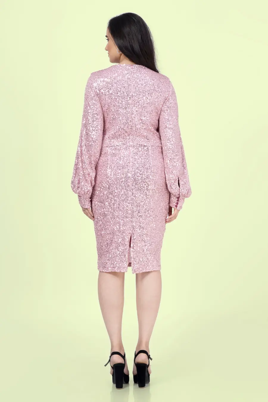 Back view of a model wearing a sheath dress with keyhole