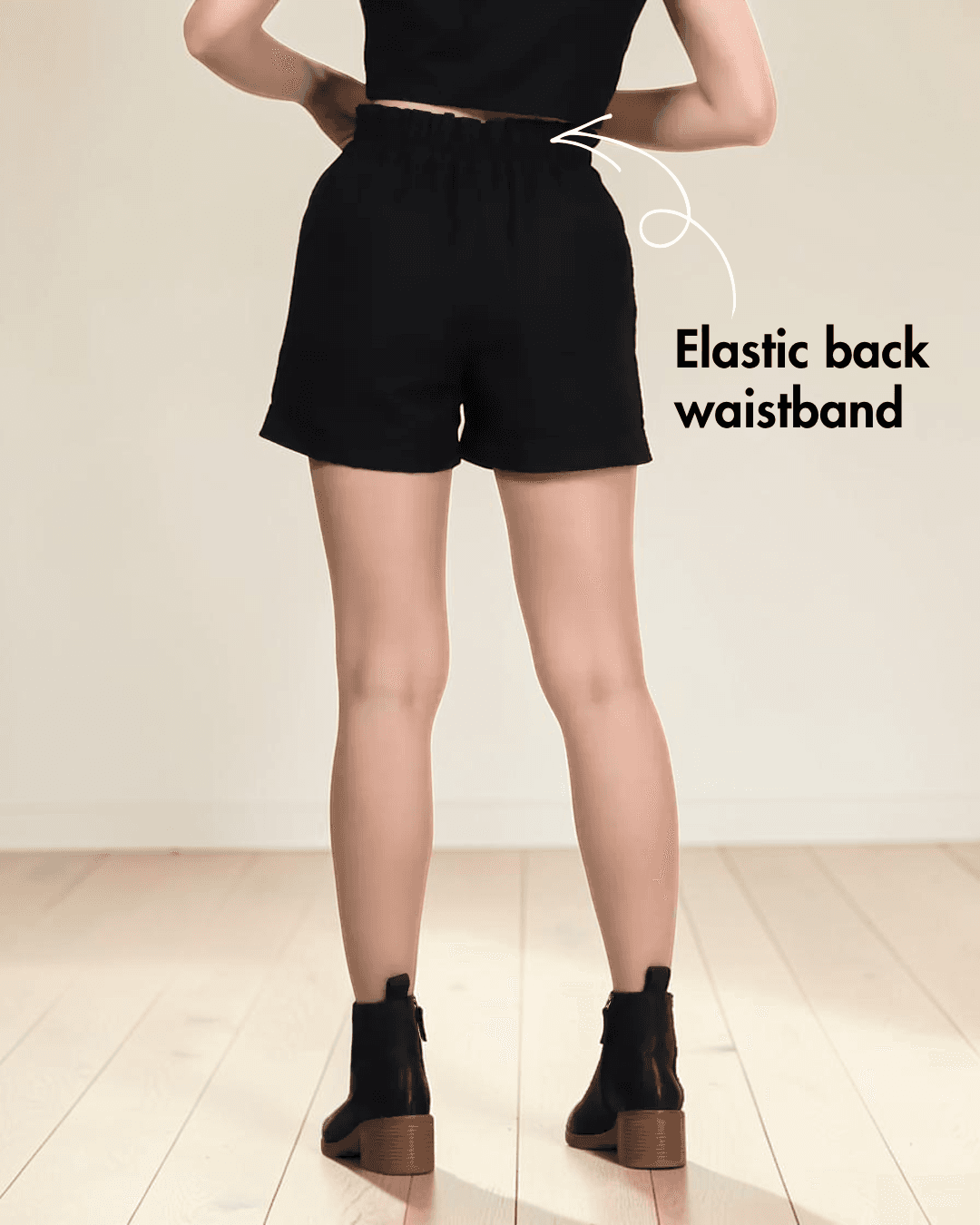 Back view of black shorts sewing pattern with elastic waistband and buttons