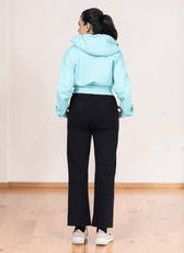 Back view of light blue cropped hoodie with hood and long sleeves