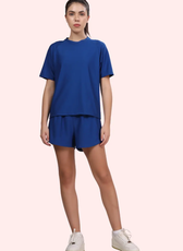 Model wearing the 'Maria' activewear coord set, consisting of a breathable raglan-sleeve T-shirt and elasticated waistband shorts. Ideal for workouts and casual wear.