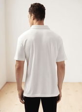 Back view of men's white polo shirt with straight hem, casual fit, sewing pattern details