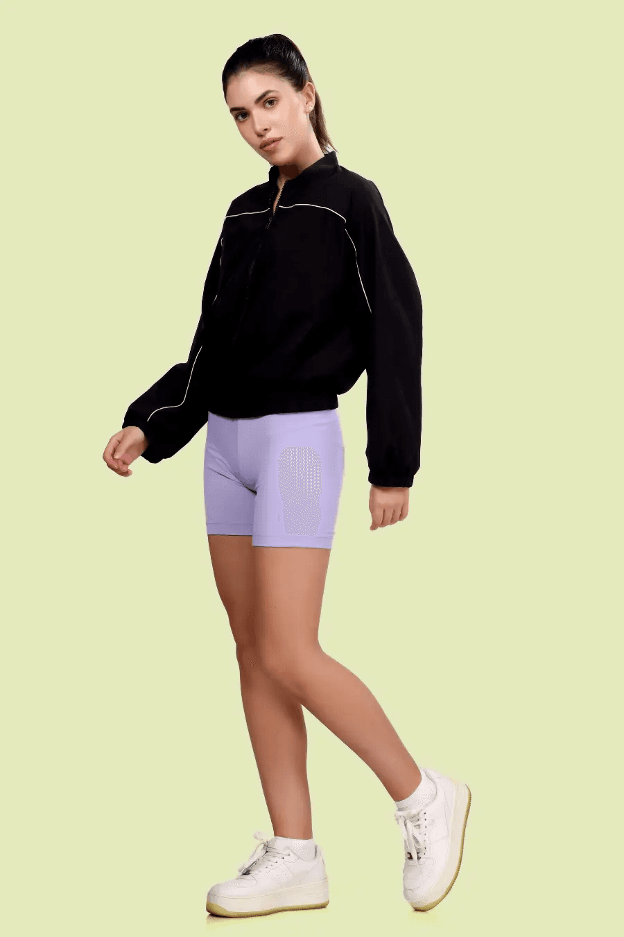 Model walking in the Naomi windbreaker, paired with casual activewear. A modern and stylish sewing pattern for a lightweight jacket.
