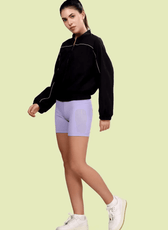 Model walking in the Naomi windbreaker, paired with casual activewear. A modern and stylish sewing pattern for a lightweight jacket.
