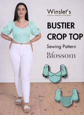 Model wearing green puff sleeve bustier crop top with shirred bodice and scoop neckline