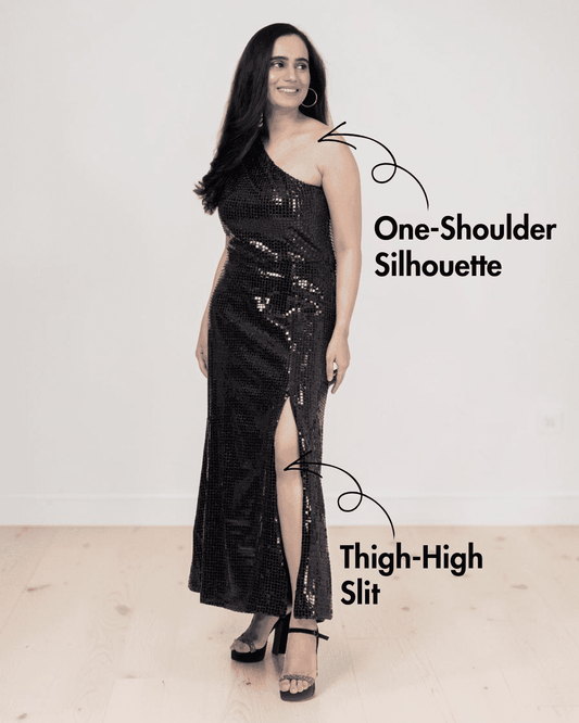 Model wearing black sequined one shoulder evening dress with thigh-high slit