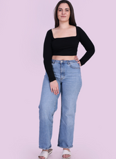 Full length Image of model wearing a black square neck top sewed with winslet's patterns paired with blue jeans