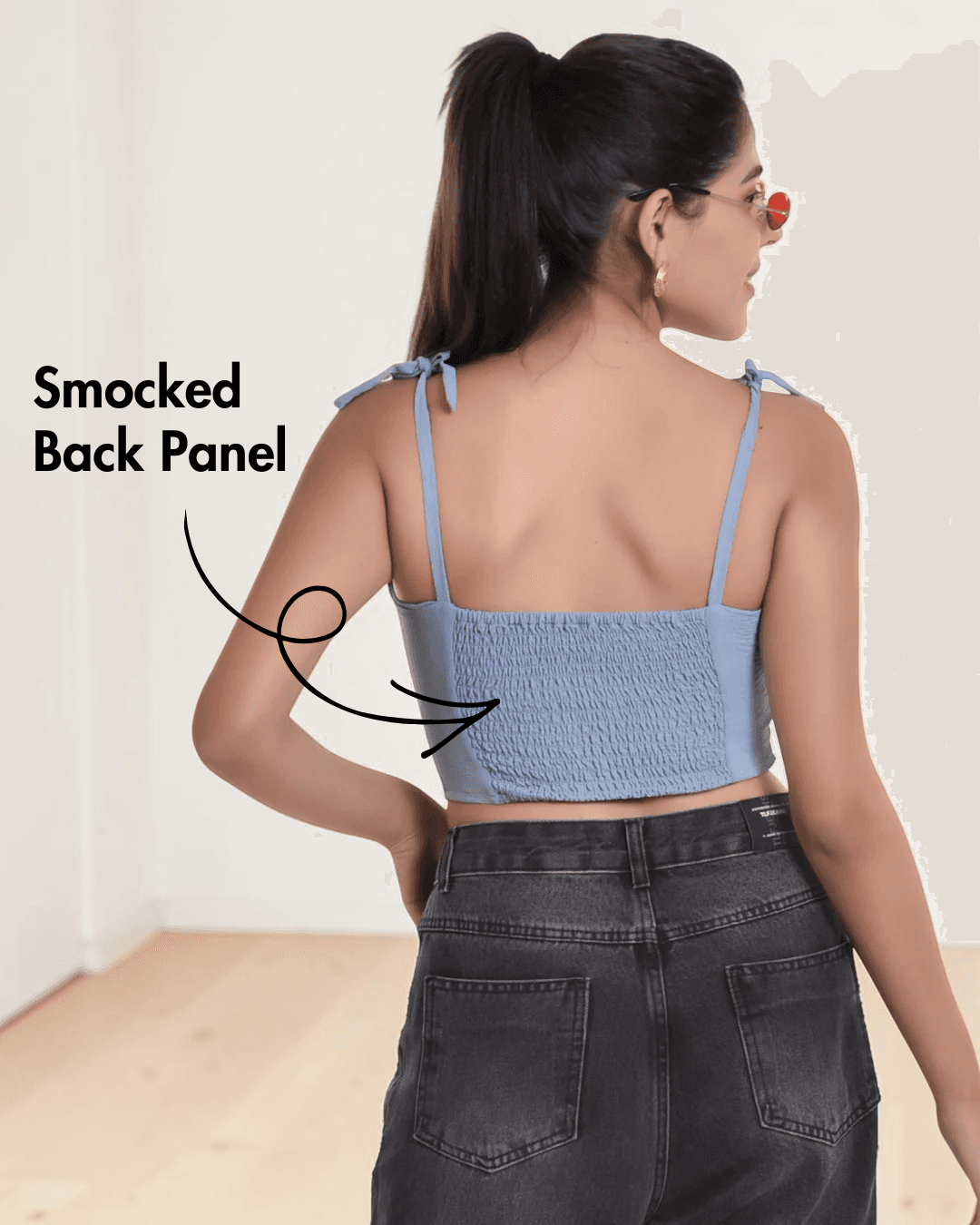 Back view of blue bustier top with smocked back panel and hook eye closure