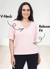 Close-up of woman in pink V-neck T-shirt, showing relaxed fit and short sleeves