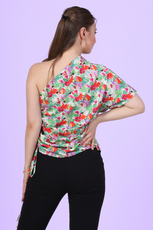 Back view of a model wearing the one shoulder kimono top paired with trousers