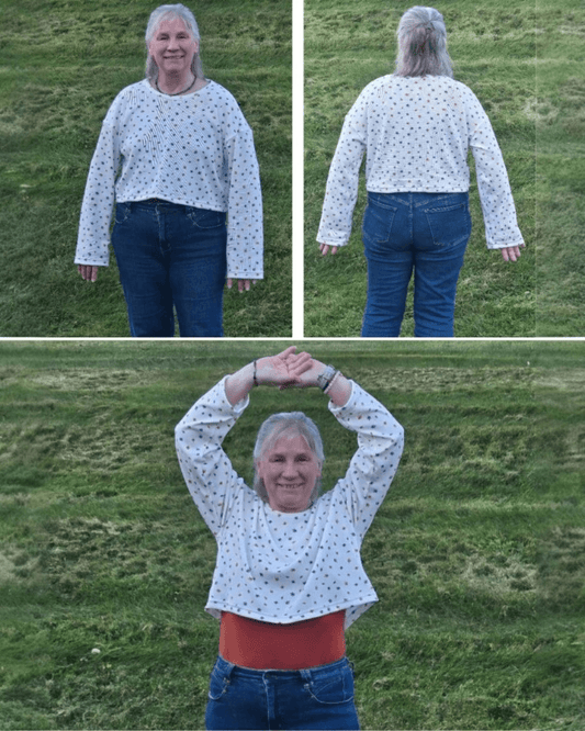 Close-up of woman smiling in star-patterned sweatshirt, showcasing round neckline, drop shoulder, sewing pattern