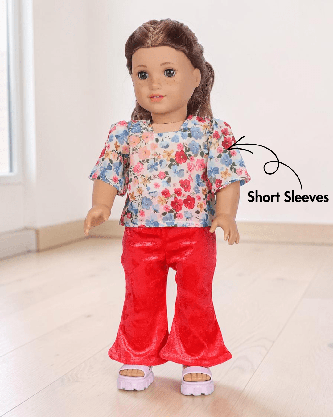 Doll in tropical print top and velvet flared pants front view sewing pattern