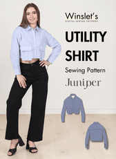 Women wearing cropped blue striped utility shirt with large pockets, long sleeves, point collar, button cuffs, and relaxed fit