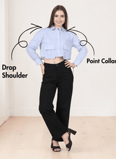 Model in cropped blue striped utility shirt with large bellows pockets, long sleeves, point collar, and black pants