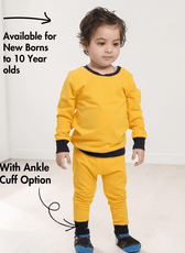Young boy in yellow sweatshirt and matching joggers with ankle cuff option, illustrating Kid's Jogging Pants Sewing Pattern for ages 0-10