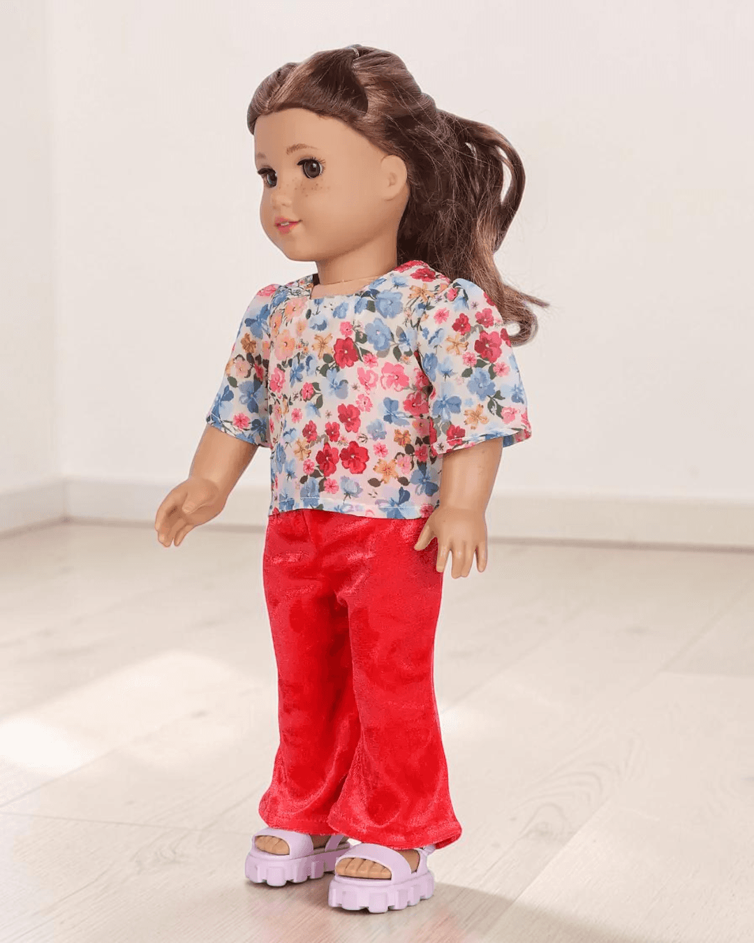 Doll with floral top and red flared pants, pink sandals sewing pattern