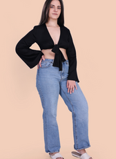 Full Length Image of a model wearing a tie front crop top sewed with winslet's patterns paired with blue jeans