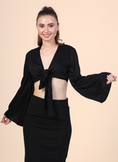 Image of a model wearing a tie front crop top sewed with winslet's patterns paired with black midi skirt