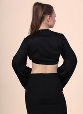 Back Pose Image of a model wearing a tie front crop top sewed with winslet's patterns paired with black midi skirt