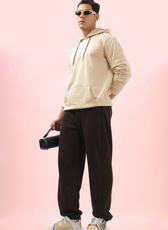 Model wearing men's joggers from the 'Louis' sewing pattern, paired with a beige hoodie. A stylish and comfortable casual outfit.