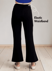 Close-up of black bell bottom pants with stylish front slits and elastic waistband