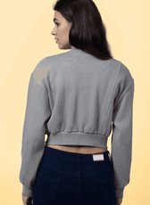 Back view of the 'Raya' bomber jacket sewing pattern, showcasing the structured paneling and ribbed waistband for a snug fit.