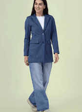 Full-length view of the 'Camille' straight-cut coat sewing pattern. The coat is styled with jeans and sneakers, showcasing its versatile and classic design.