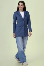 Full-length view of the 'Camille' straight-cut coat sewing pattern. The coat is styled with jeans and sneakers, showcasing its versatile and classic design.