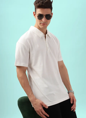 Men's polo shirt from the 'John' sewing pattern. Model poses with sunglasses, emphasizing the shirt’s relaxed yet polished look.